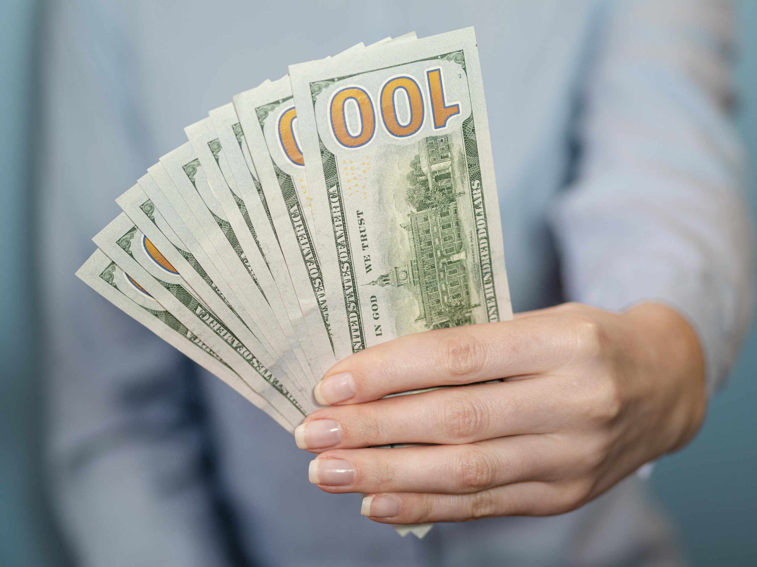 front view person holding money dollar bills